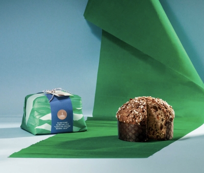 Panettone with candied apricot and Sicilian chocolate topped with icing and hazelnuts